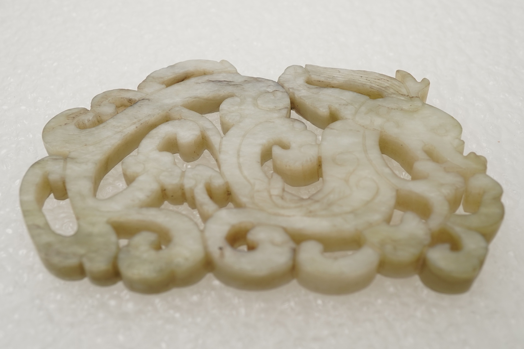 A Chinese white and grey mottled jade ‘chilong’ plaque, Ming dynasty